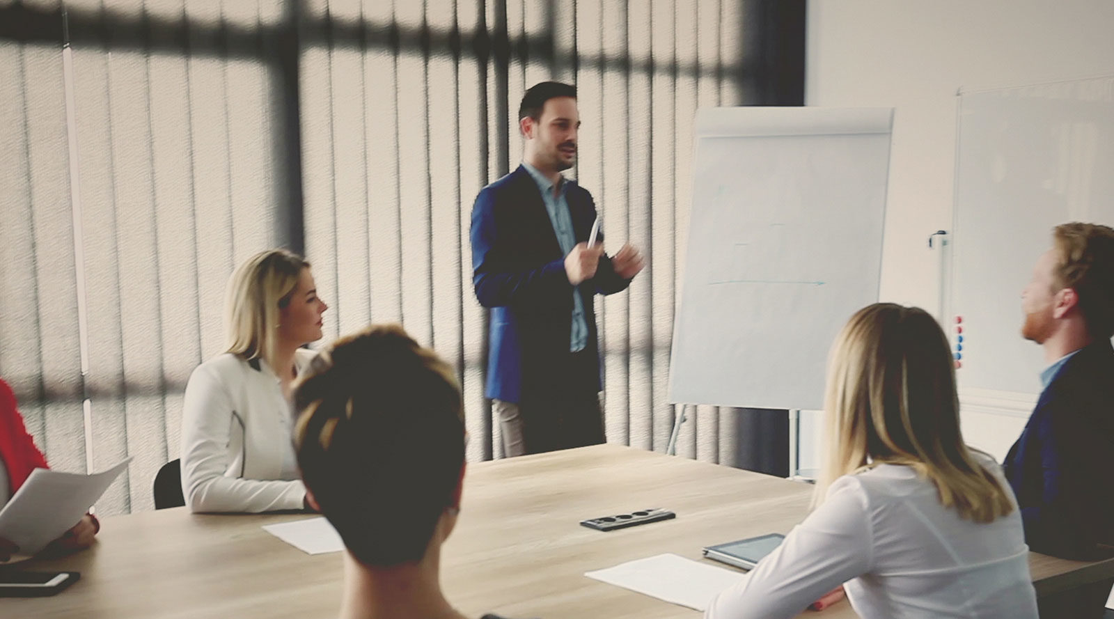 man-giving-presentation-to-colleagues-meeting-room-iSpeak